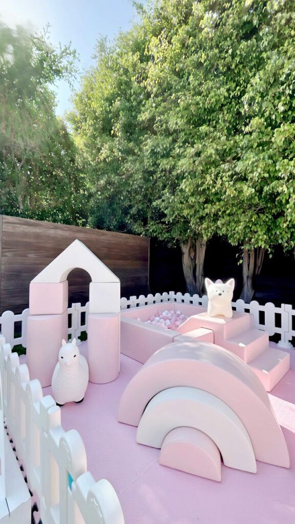 Pink and white soft play with house arch and ball pit