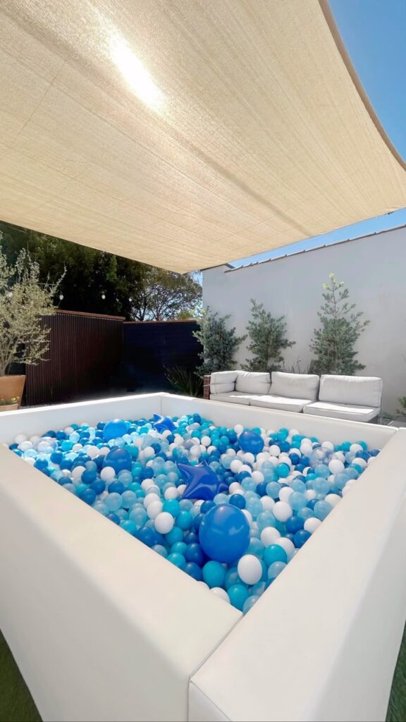 Blue and white ball pit on a shaded patio
