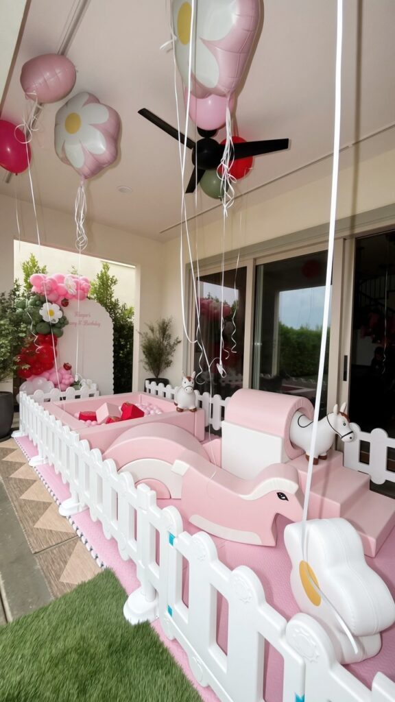 Pink soft play with balloons at an indoor celebration