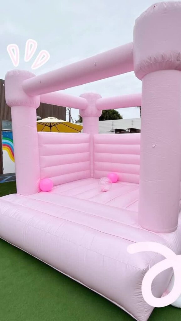 Pink bounce house on grass